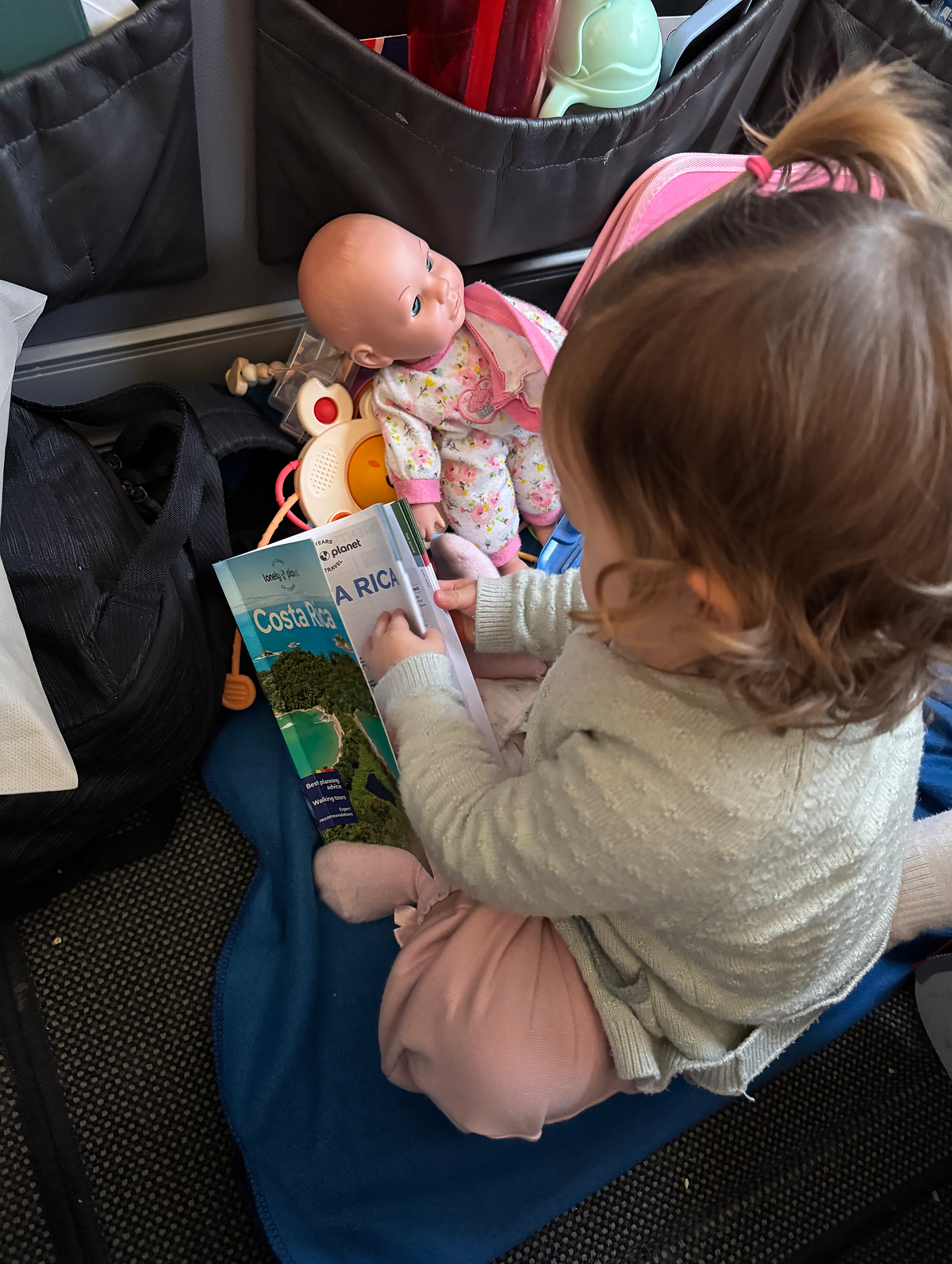 TIPS FOR FLYING LONG HAUL WITH A TODDLER Baby reading book
