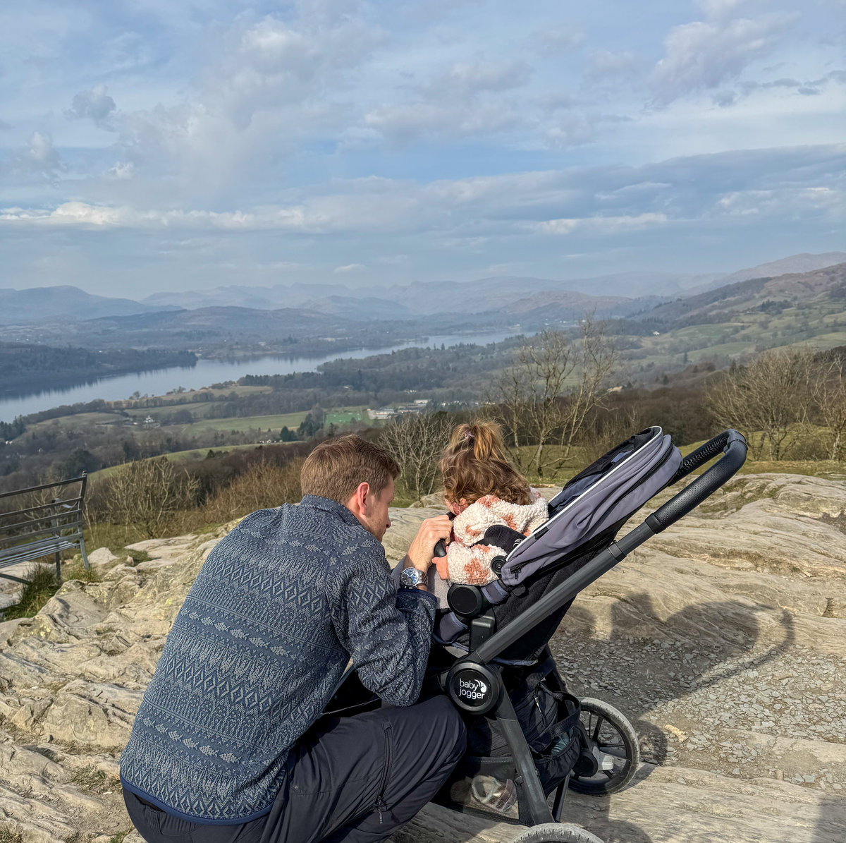man and baby and view of lake 