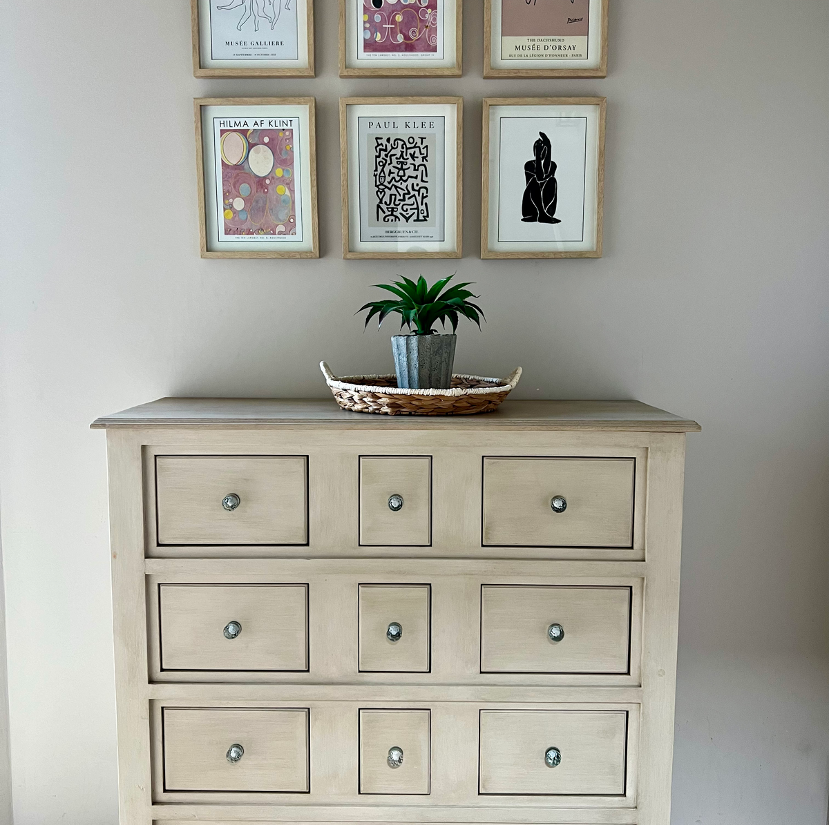 chest of drawers and pictures on wall